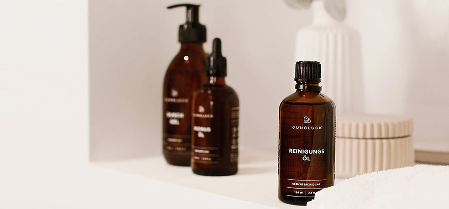 Three Junglück products in amber glass bottles