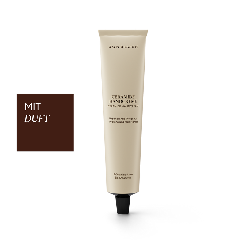 Beige tube of Junglück Ceramide Handcreme with black cap and German text detailing fragrance and care benefits.