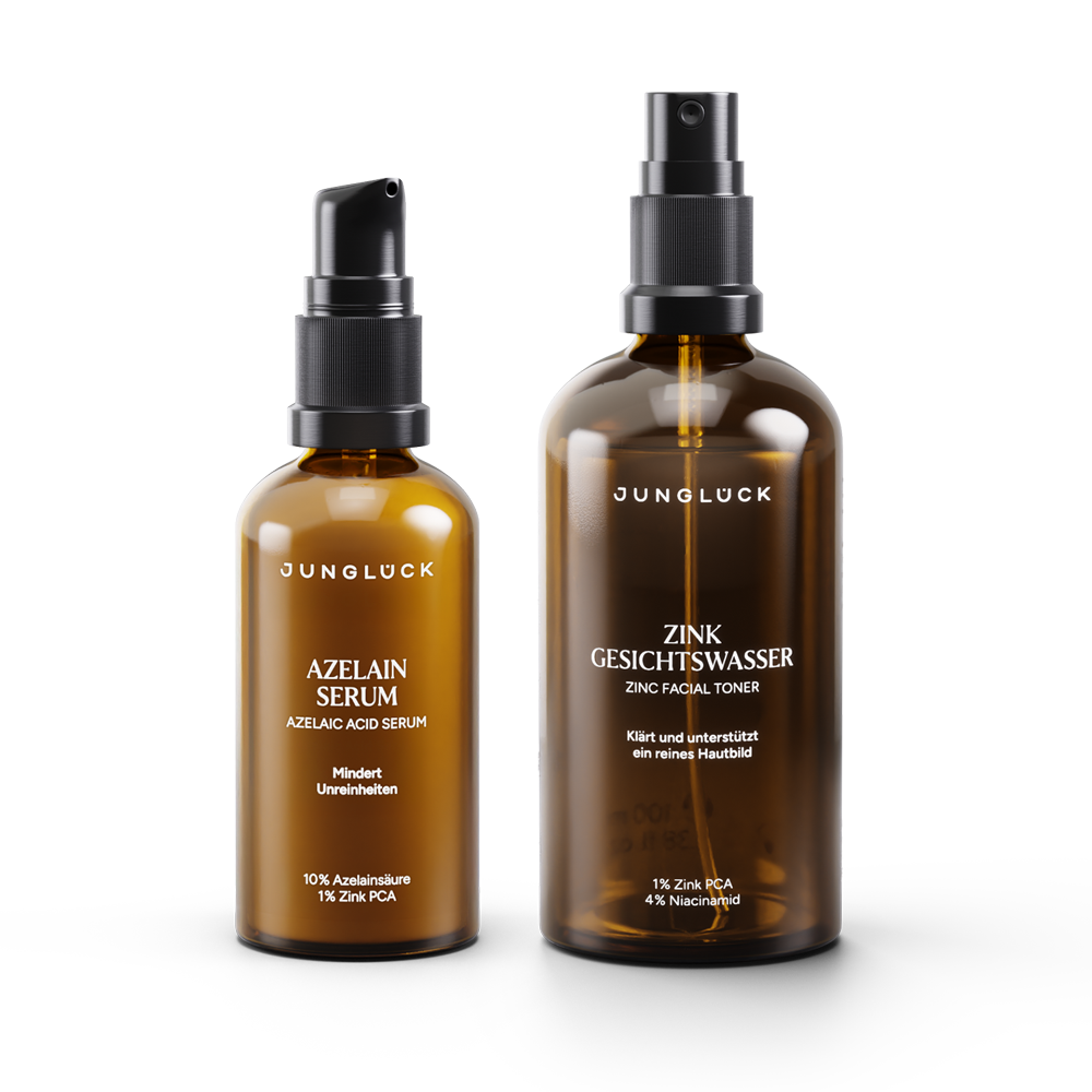 Amber glass bottles with black pump and spray tops, labeled Azelain Serum and Zinc Facial Toner.