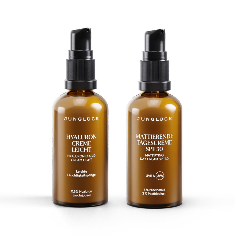 Two amber glass bottles stand side by side, one containing a light hyaluronic acid cream and the other a mattifying day cream.