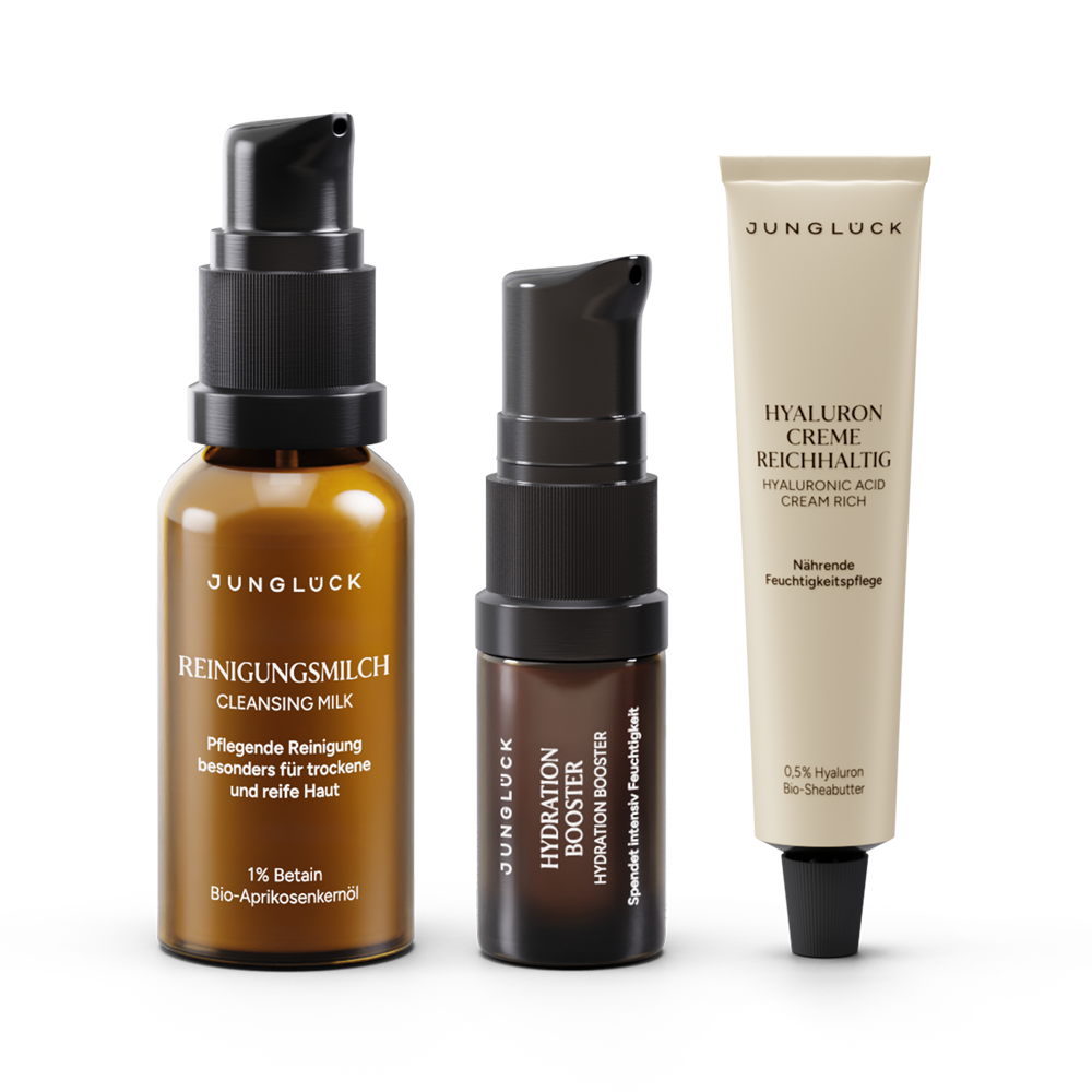Introductory set with three JUNGLÜCK products: " Cleansing Milk " in an amber glass bottle, Intensiv Booster, Hyaluron " cream," all for