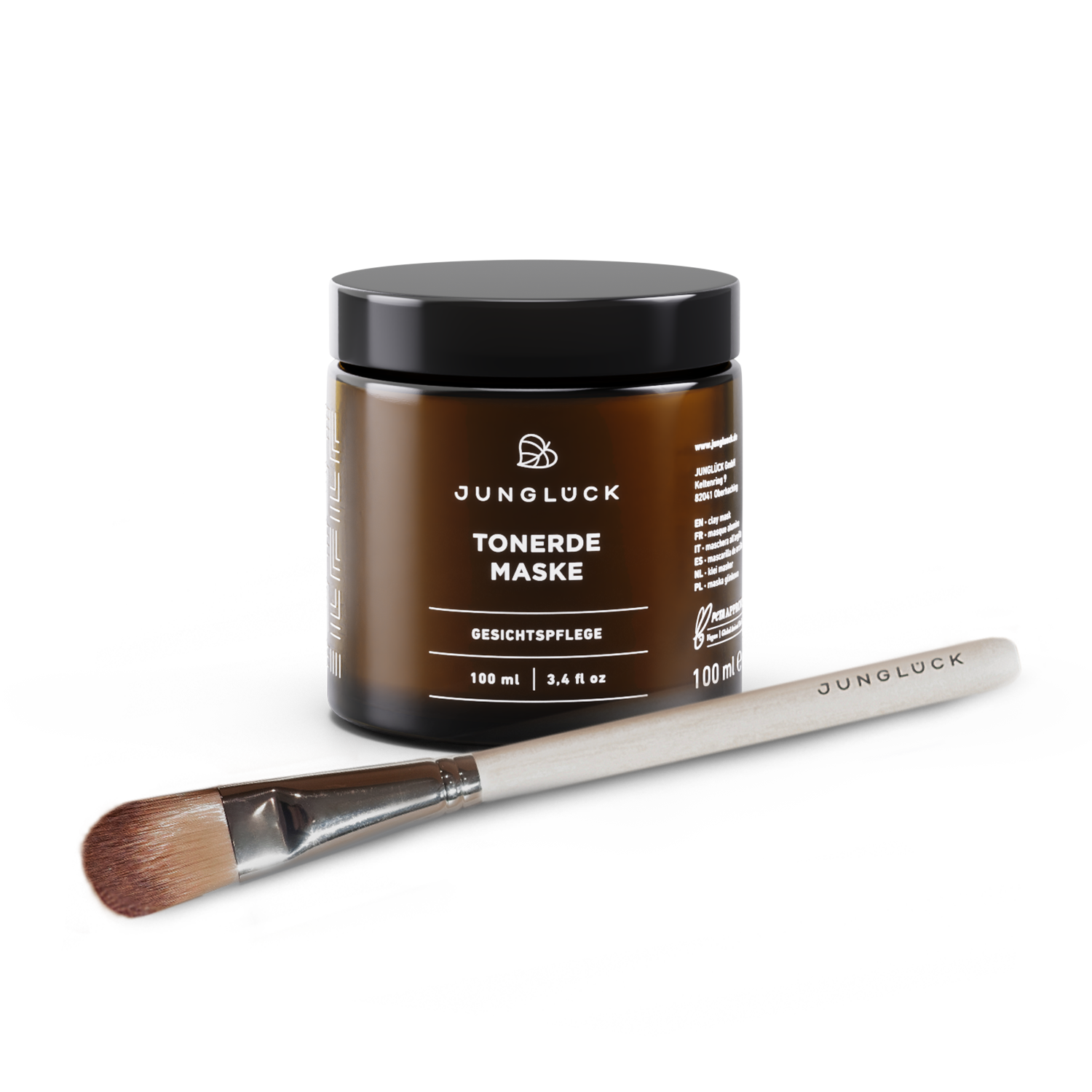 Kleimasker in een bruine glazen pot van 100 ml, naast een kwastje om het product aan te brengen.
